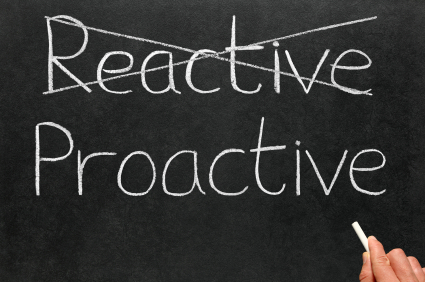 Blackboard with 'Reactive' crossed out and 'Proactive' written underneath