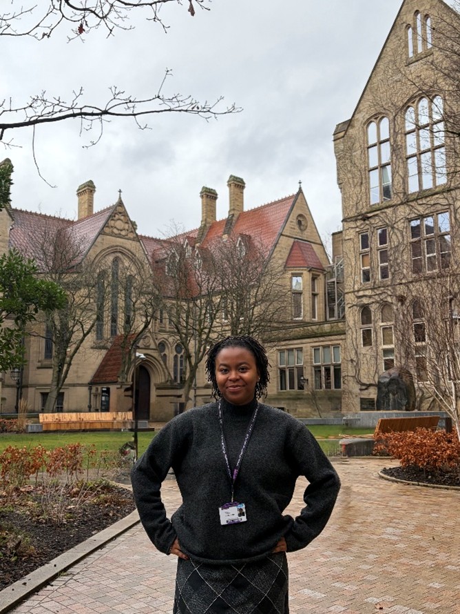 Ife standing in front of the buildings in UoM quad